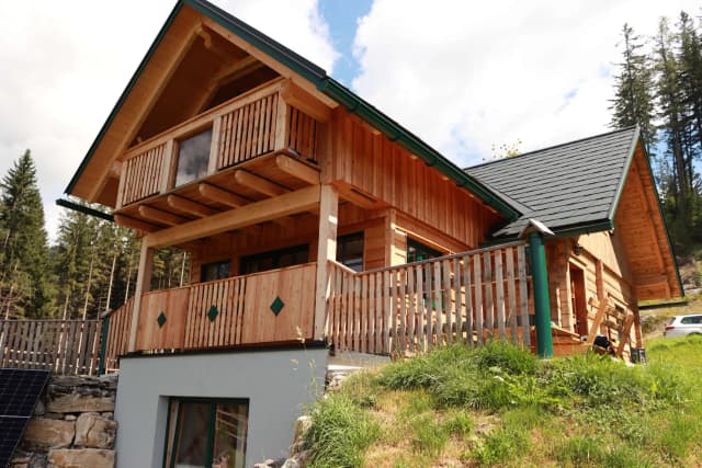 A charming wooden cabin nestled in the hillside with modern touches.